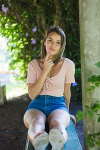 Portrait of smiling woman sitting outdoors