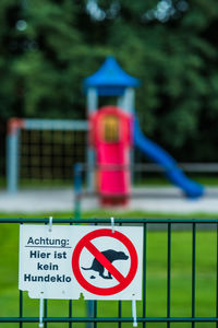 Close-up of road sign against blurred background