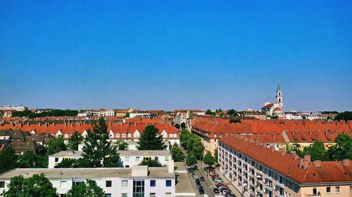 Buildings in town against blue sky