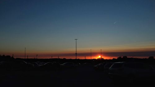 Traffic on road at sunset