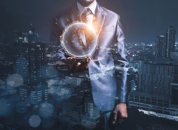 Digital composite image of man working with cityscape