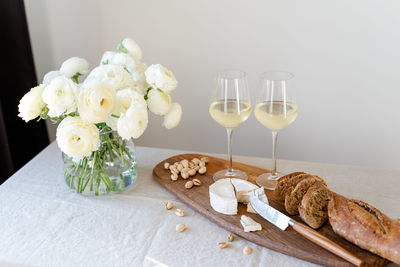 Close-up of white roses in vase on table