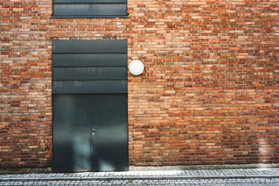 Closed door of brick wall