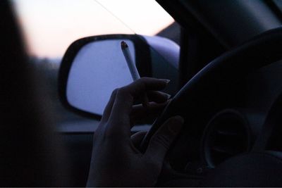 Close-up of woman using smart phone in car
