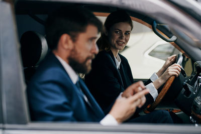 Man and woman sitting in car