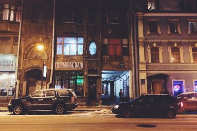 Cars in illuminated city at night