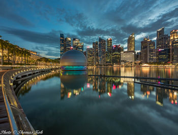 Reflection of buildings in city against sky