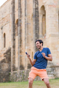 Side view of young man exercising in city