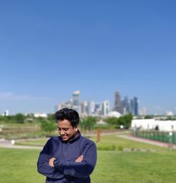 Young man on field against sky