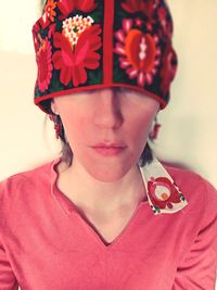 Close-up portrait of woman with red flower
