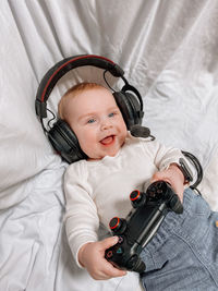 Gamer baby with headphones and game pad