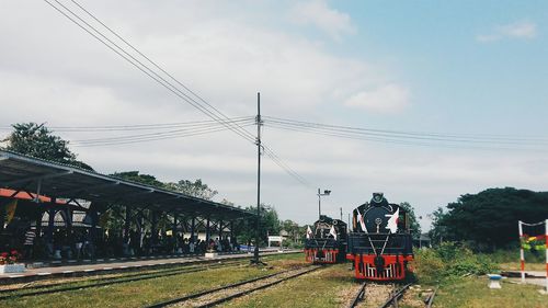 Railroad track against cloudy sky