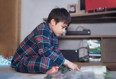 Side view of boy looking at camera