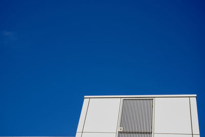 Low angle view of building against clear blue sky