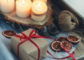 High angle view of gift box with candles on table