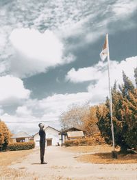 Full length of man standing at beach against sky