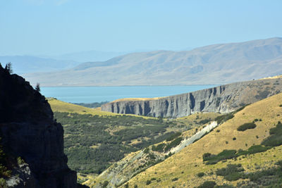 Scenic view of landscape and mountains against clear sky