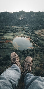 Low section of man relaxing on mountain