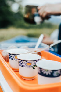 Close-up of hand holding ice cream on table