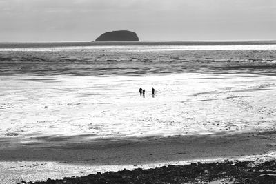 Three people in the ocean desert