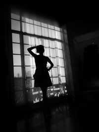 Silhouette woman walking in corridor