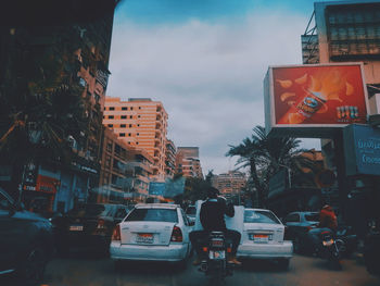 Traffic on road against buildings in city