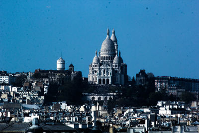 View of buildings in city against clear sky