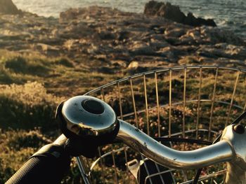 Close-up of bicycle on landscape