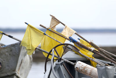 Close-up of rope tied on wooden post at beach against sky