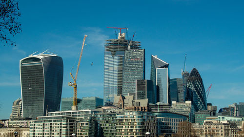 Modern buildings in city against sky