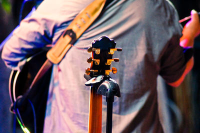 Close-up of man playing guitar