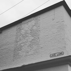 Low angle view of sign board against sky