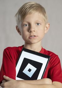 Portrait of boy holding book