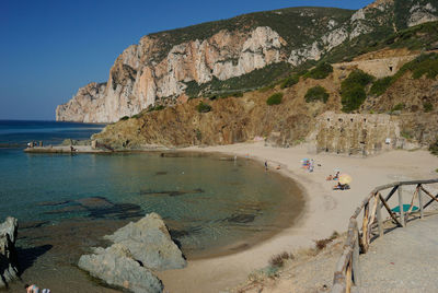 Scenic view of sea and mountains against sky