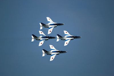 Low angle view of airplane flying against sky