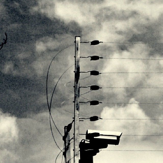 low angle view, sky, cloud - sky, cloudy, silhouette, outdoors, day, weather, overcast, cloud, metal, no people, technology, part of, wood - material, nature, cable, in a row, tall - high, railing