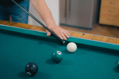 Cropped hand playing pool