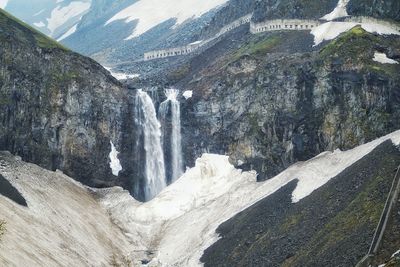Scenic view of mountains and waterfall during winter