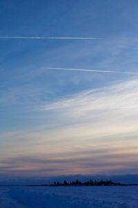 Scenic view of vapor trails in sky during winter