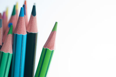 Close-up of colored pencils against white background