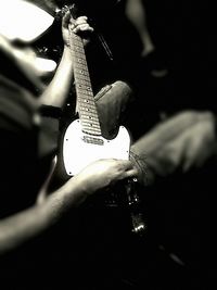 Cropped image of man holding guitar