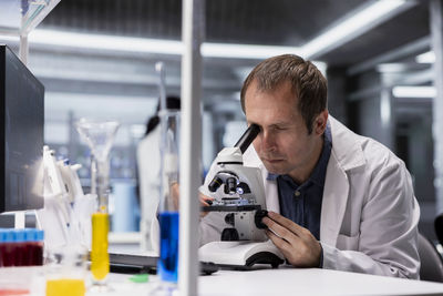 Side view of man working in laboratory