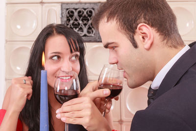 Young couple having drinks while sitting at restaurant