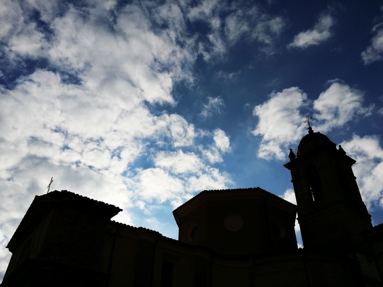 architecture, building exterior, low angle view, built structure, sky, church, religion, place of worship, spirituality, cloud - sky, cathedral, silhouette, cloud, steeple, high section, outdoors, cloudy, tower