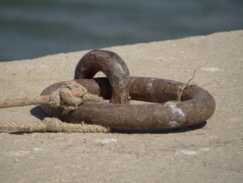 Close-up of rope tied up on rusty metal