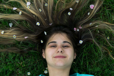 Portrait of young woman lying on grass