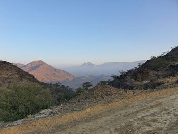 Scenic view of mountains against clear blue sky