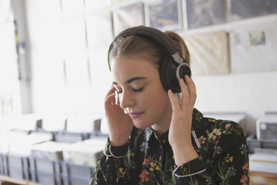 Young woman listening to music at a record store