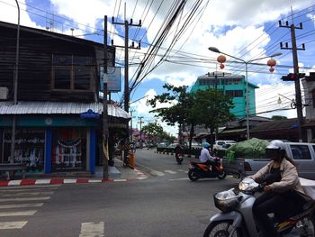 Buildings in city against cloudy sky