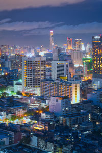 High angle view of illuminated buildings in city at dusk